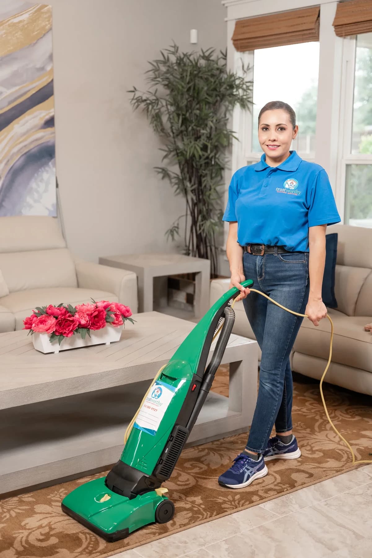 Cleaner vacuuming a living room floor