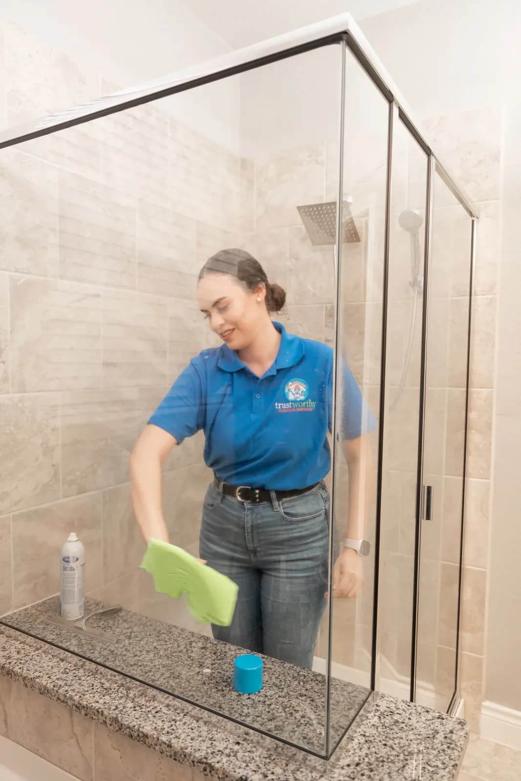 A Trustworthy cleaner removing hard water spots from shower glass in Austin, TX