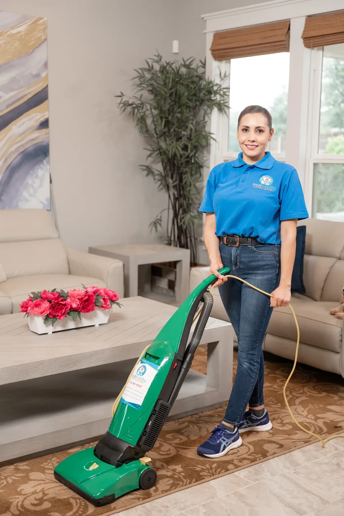 Cleaner vacuuming a living room floor