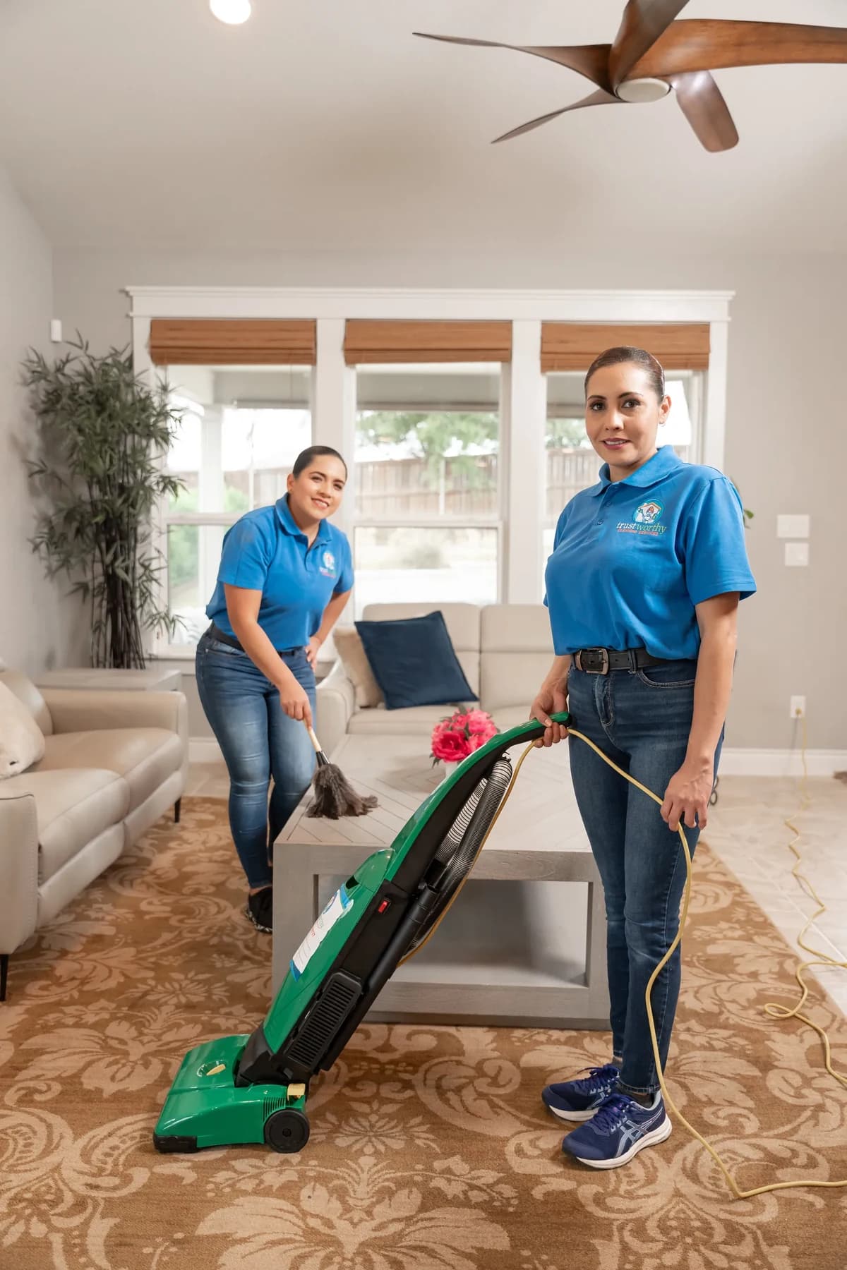 Cleaner vacuuming a living room floor