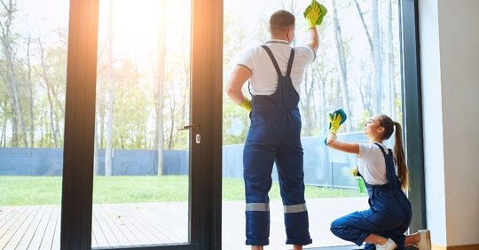 man and woman clean ing windows