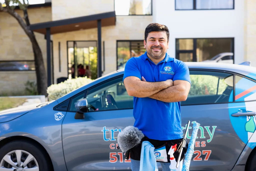 Trustworthy Cleaning Services team member standing beside a branded company van before a commercial cleaning job in Austin, Texas